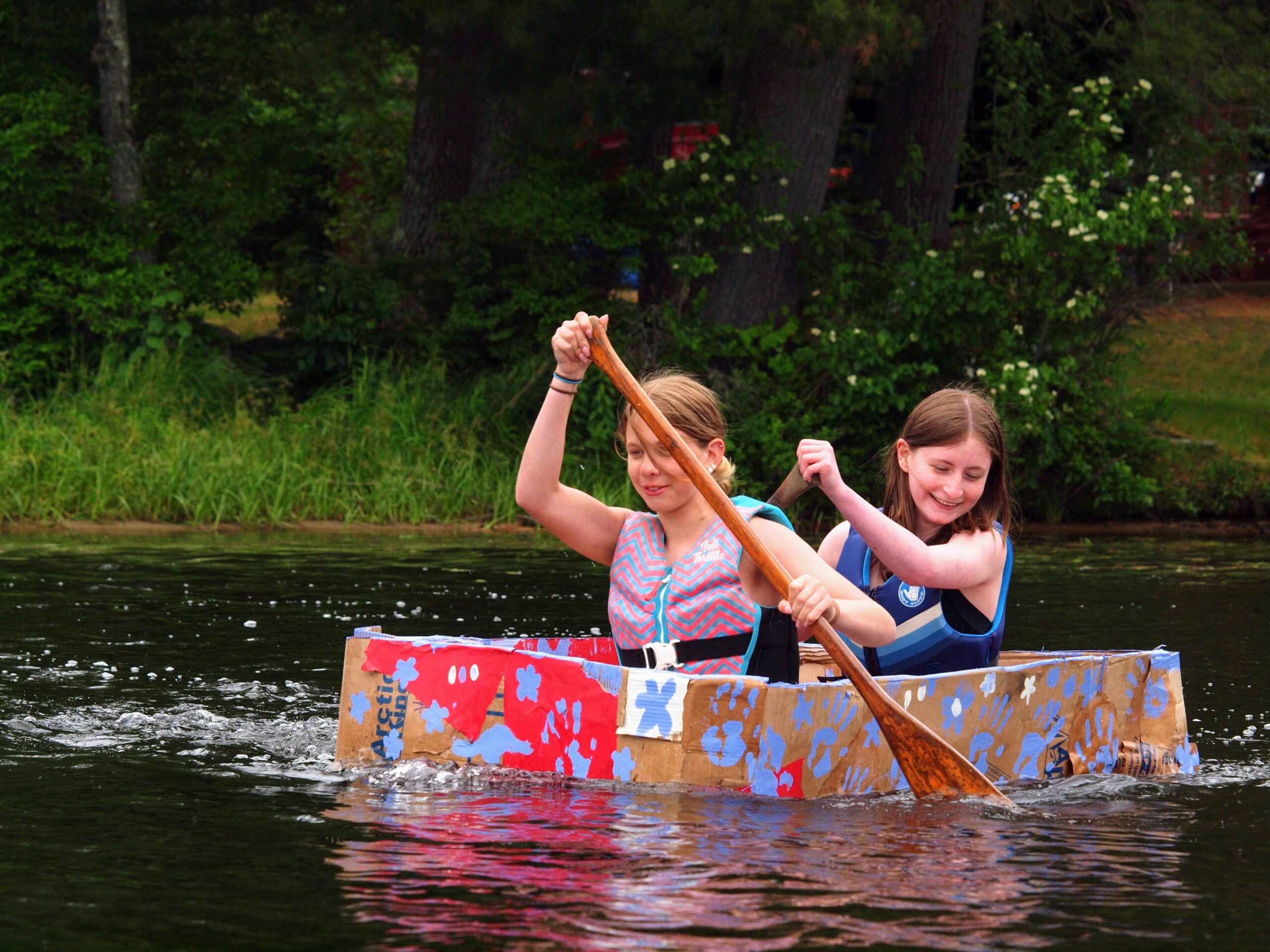 Students row a cardboard boat