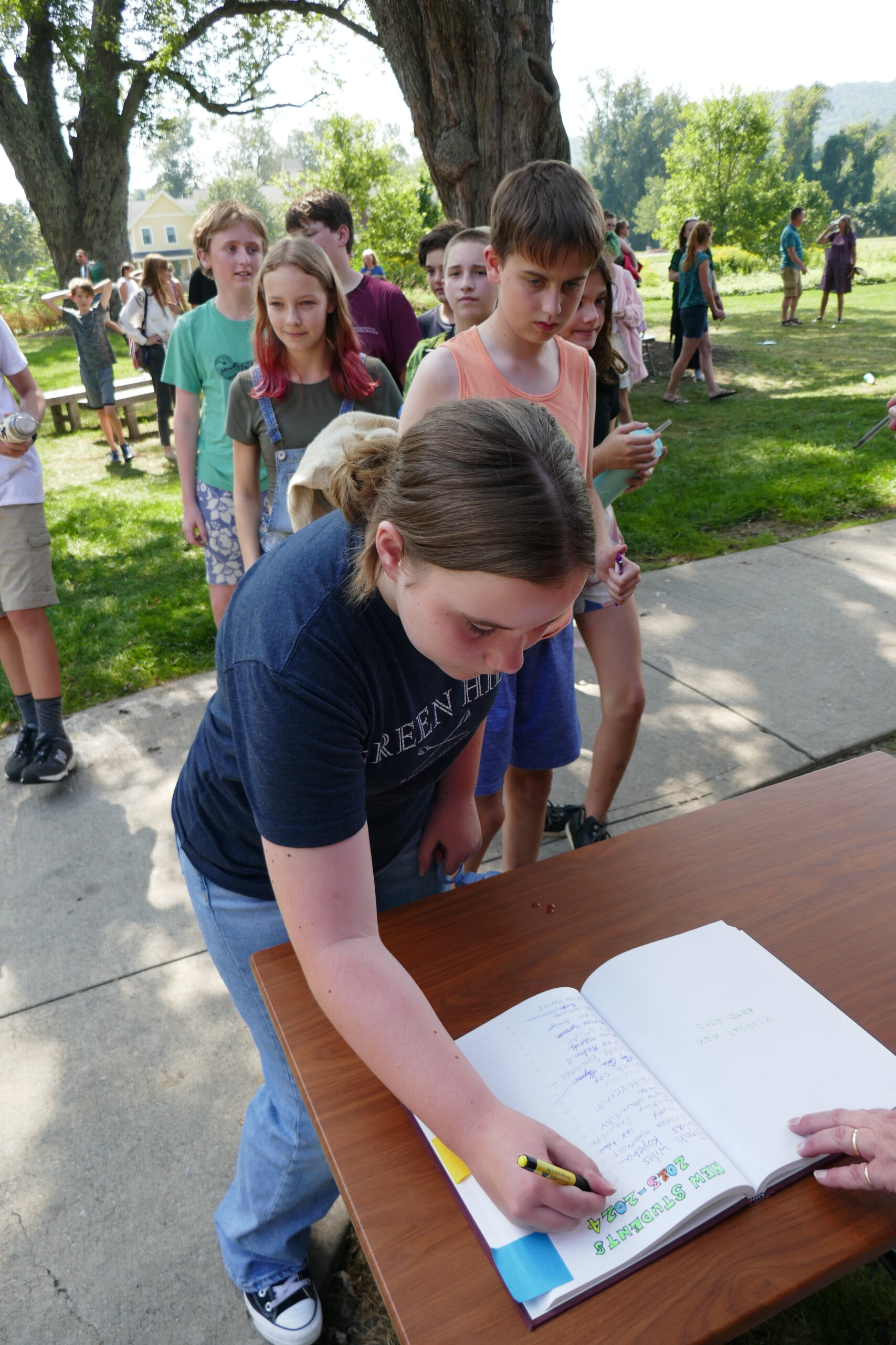 Students sign the book of names