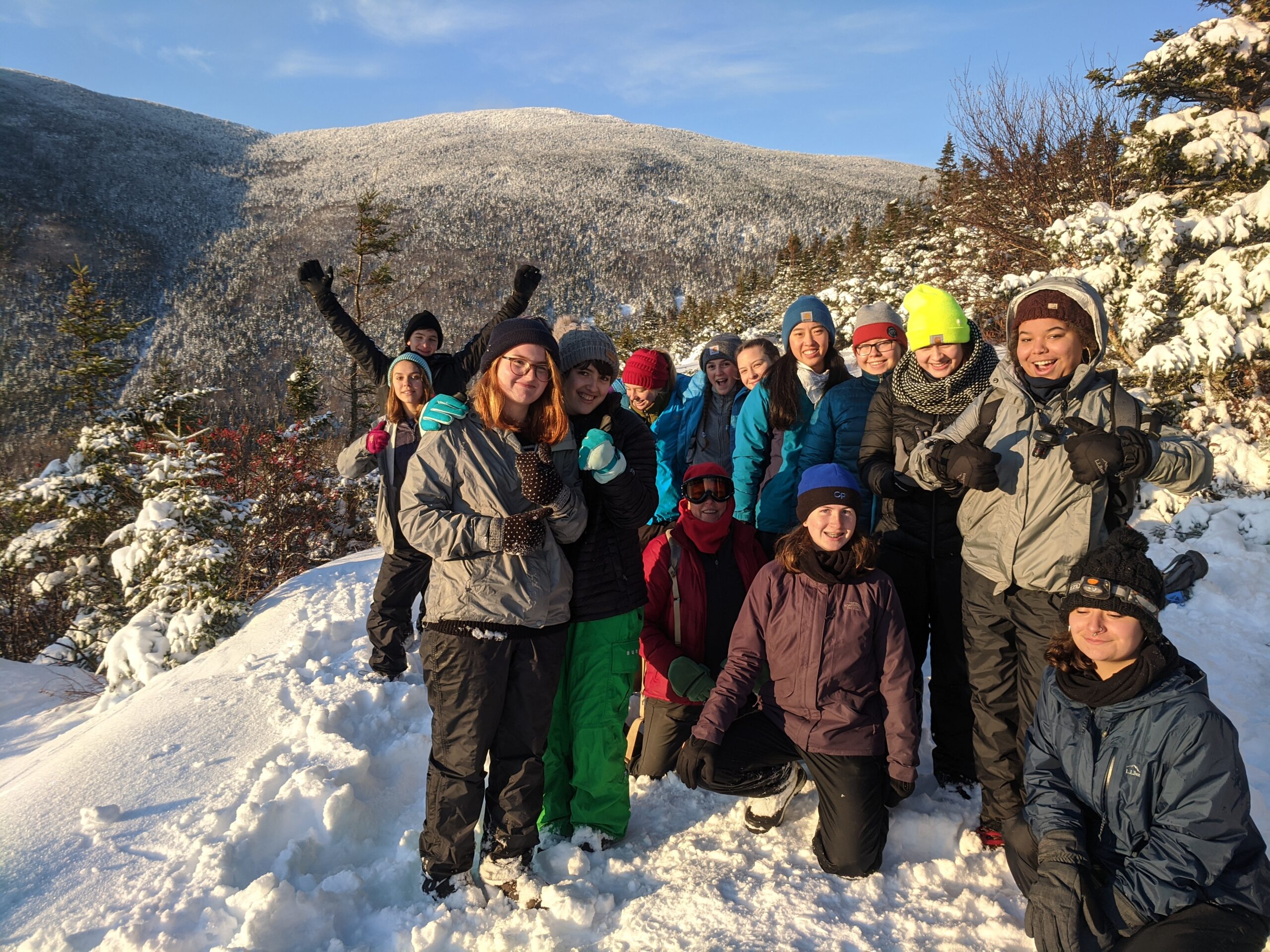 Students pose at the top of a mountain