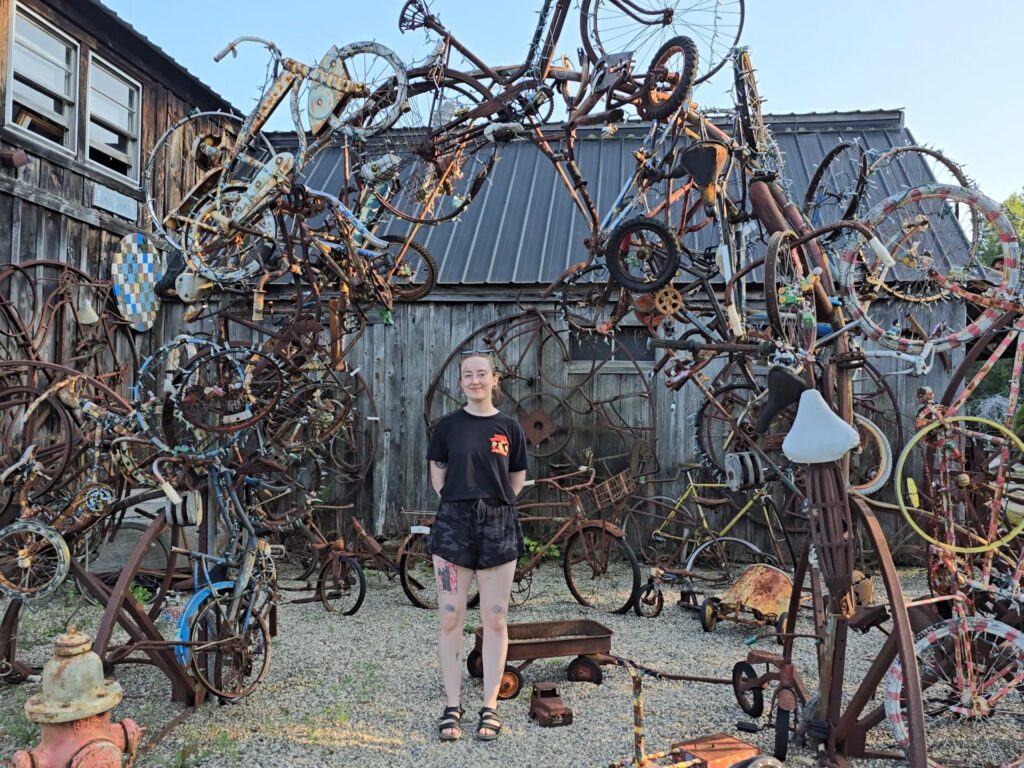 Renna Earp stands amidst a metalwork sculpture