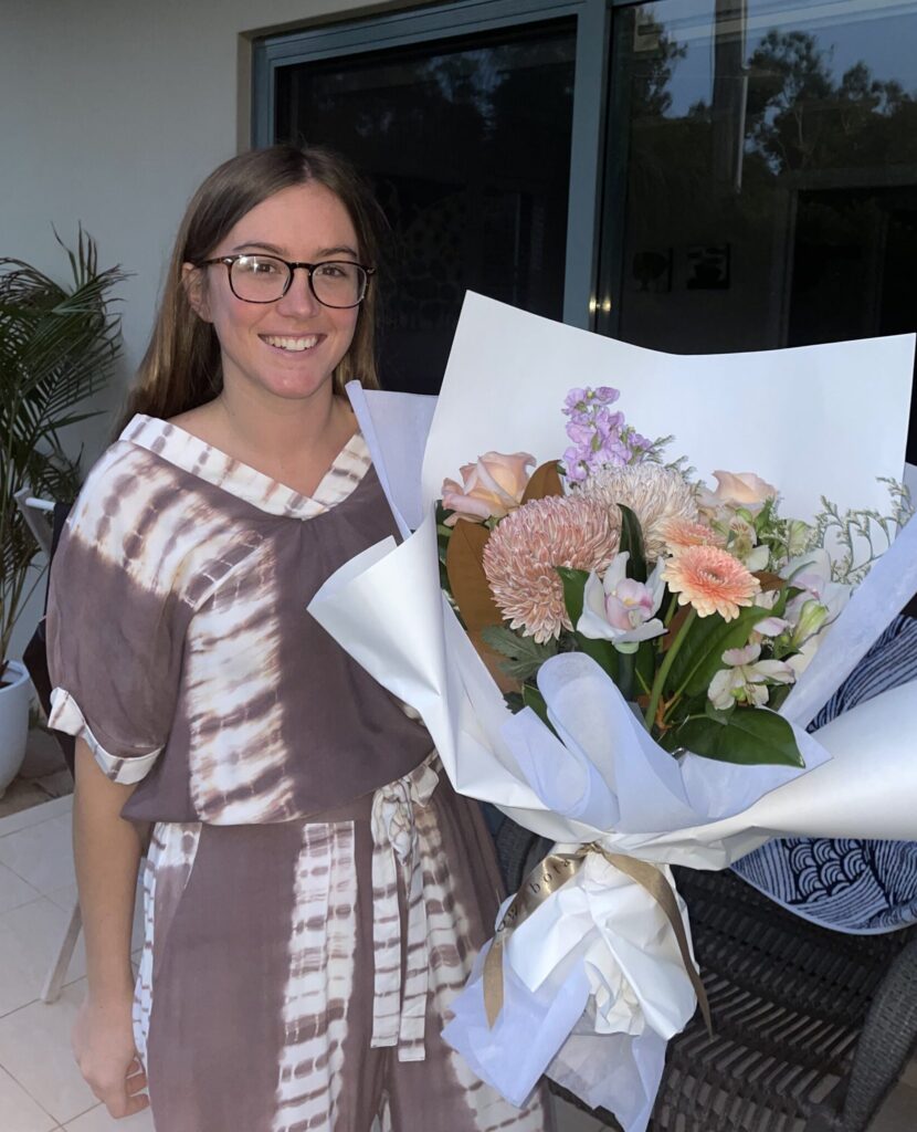 Sarah Slade holds a bouquet of flowers